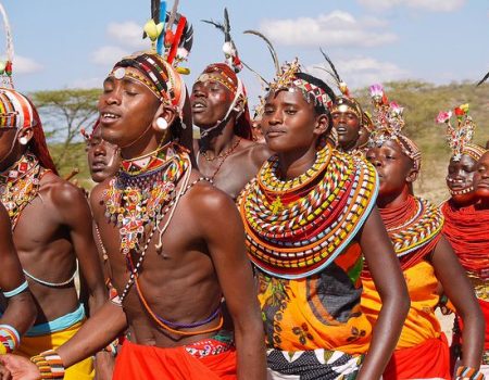 Maasai warrior dancing during village tour clothes and headdresses